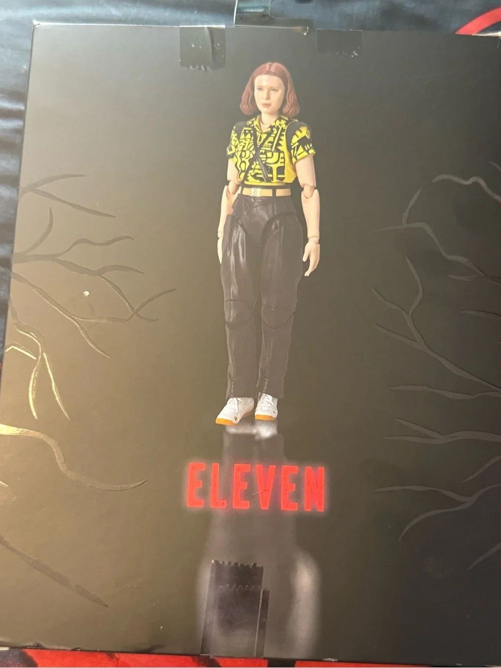 Netflix Stranger Things Eleven Figure - Yellow & Black